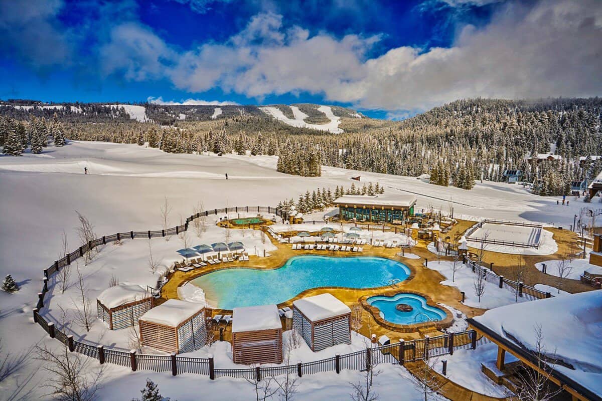 Aerial view of snowy resort and outdoor swimming pool
