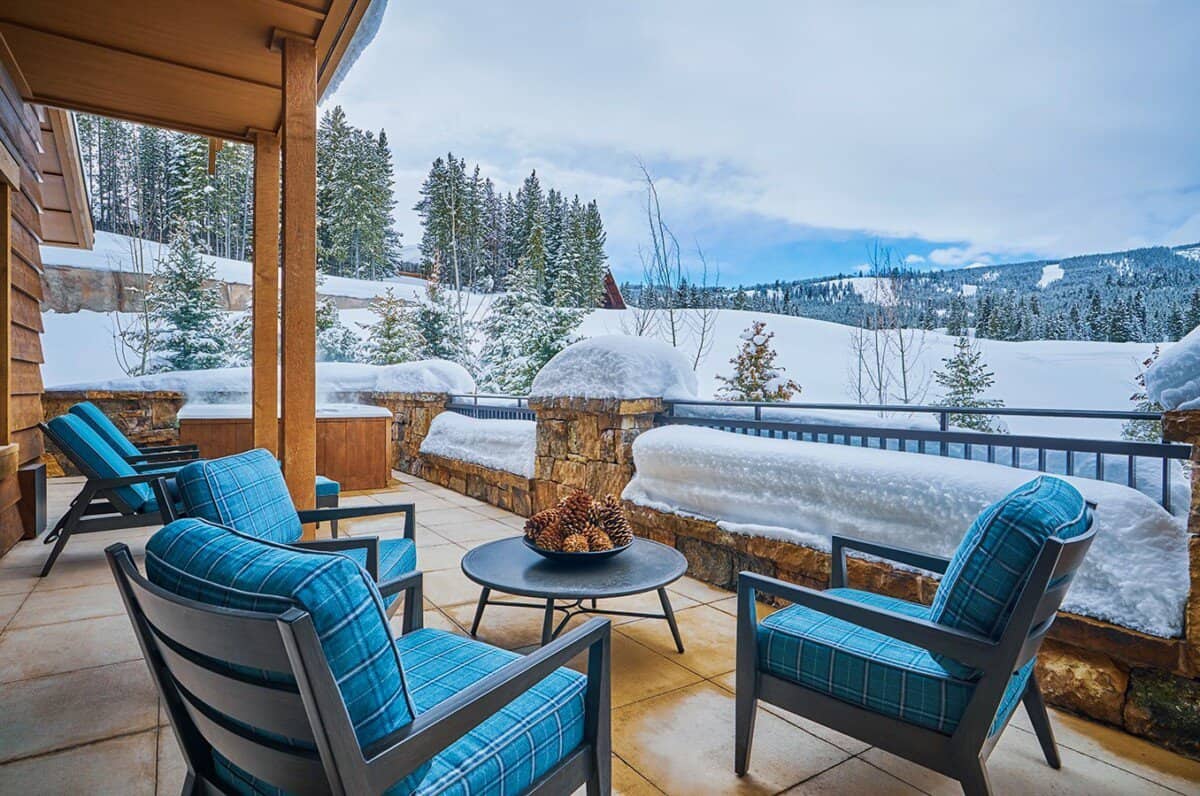 Patio area with blue chairs and snowy landscape in the background