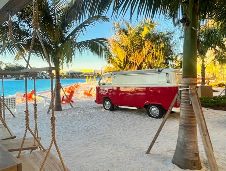 retro red van sitting on beach overlooking pool at Evemore Orlando Resort