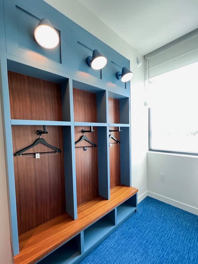 open closet with hangers and window with sunlight at Evemore Orlando Resort