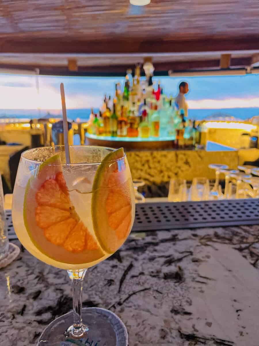 tropical beverage with backdrop of a bar at Four Seasons Resort Punta Mita