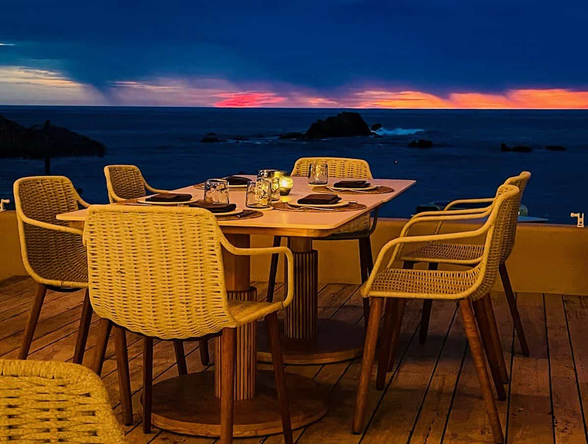 outdoor dining table overlooking the ocean at night