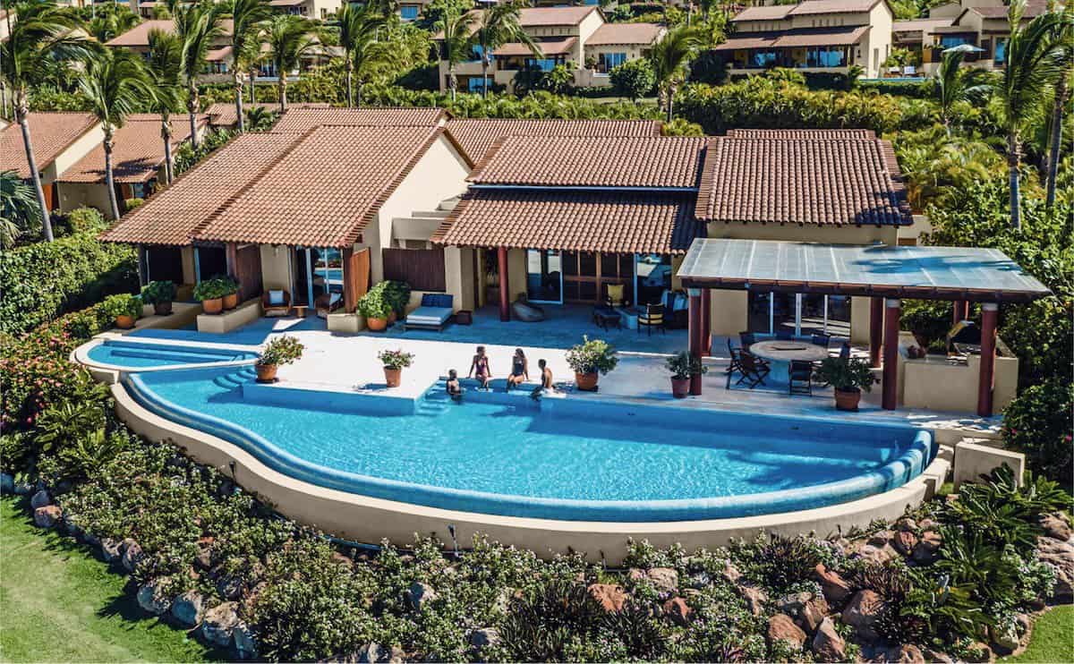 aerial view of large villa with people sitting at an outdoor poo