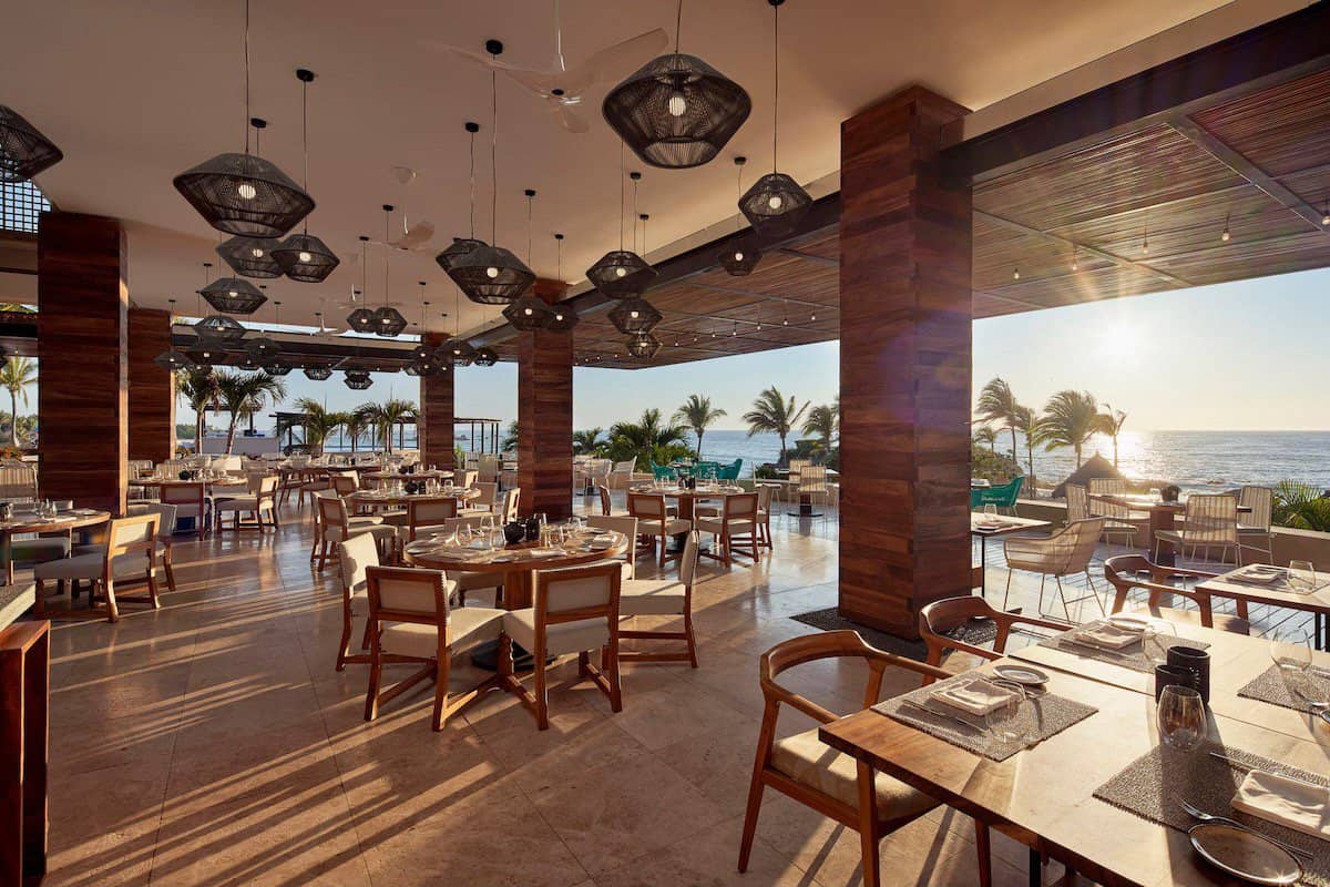 indoor and outdoor dining area overlooking the ocean at Four Seasons Resort Punta Mita