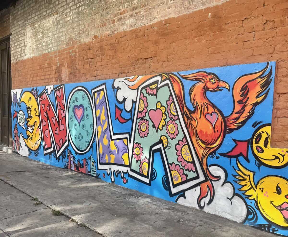 colorful street mural that says Nola