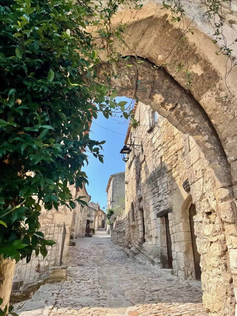 long archway with a row of historic buildings in Provence