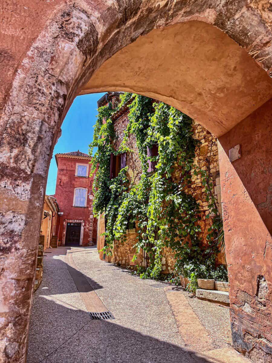 under the archway with views of colorful historic buildings in backdrop