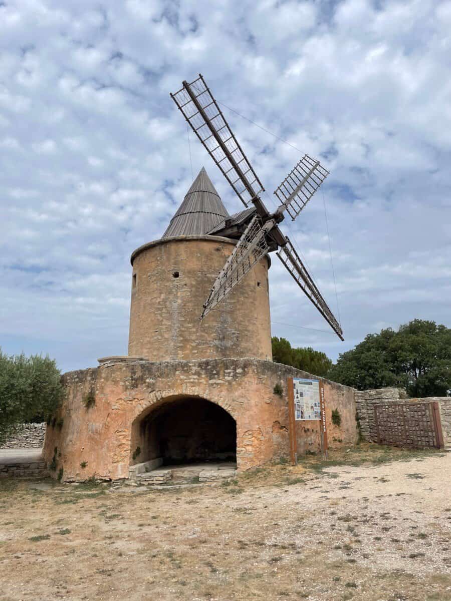 historic windmill with gray clouds in backdrop