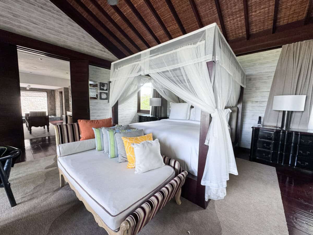 interior of bedroom with canopy bed with white linen