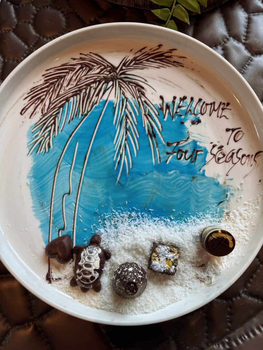 a decorative plate saying welcome to four seasons