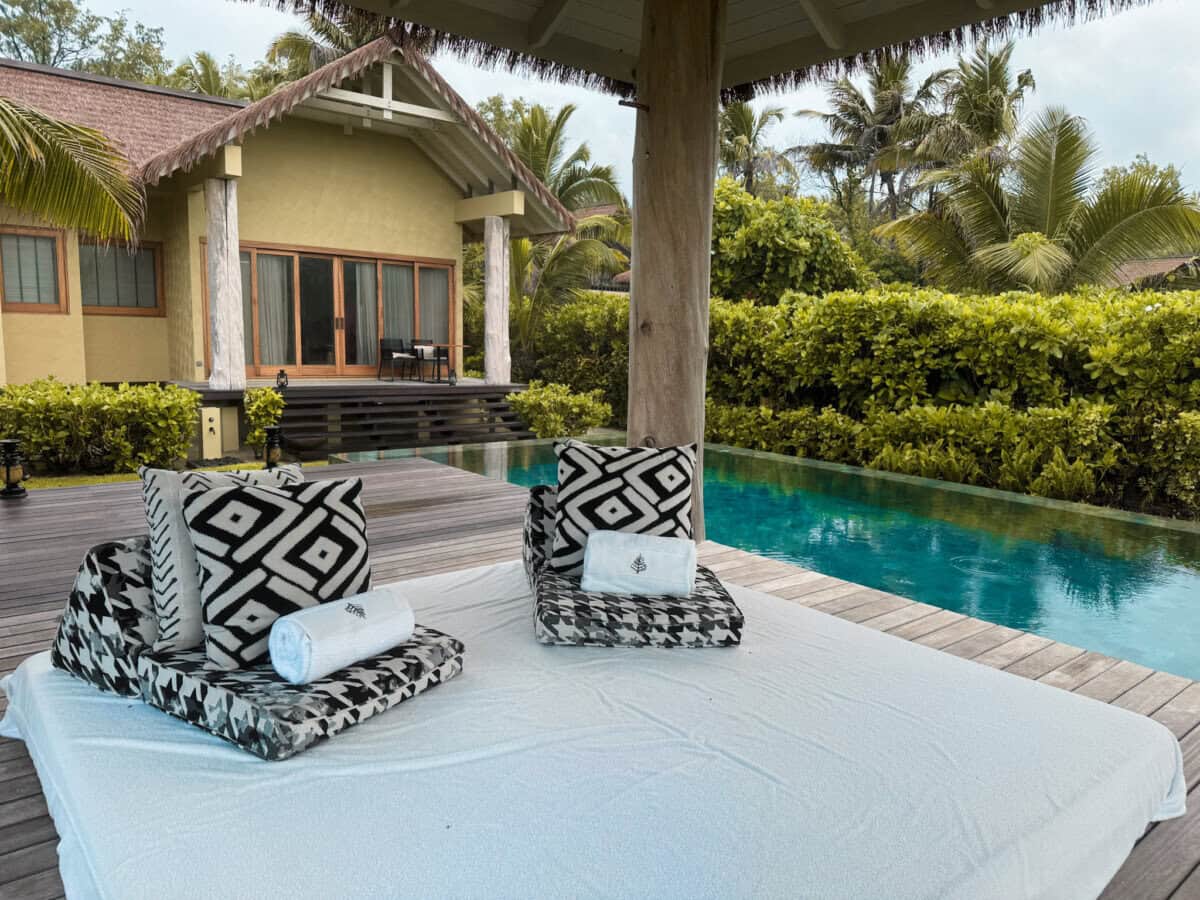 outdoor space with black and white seating and outdoor pool at Four Seasons Seychelles Resorts