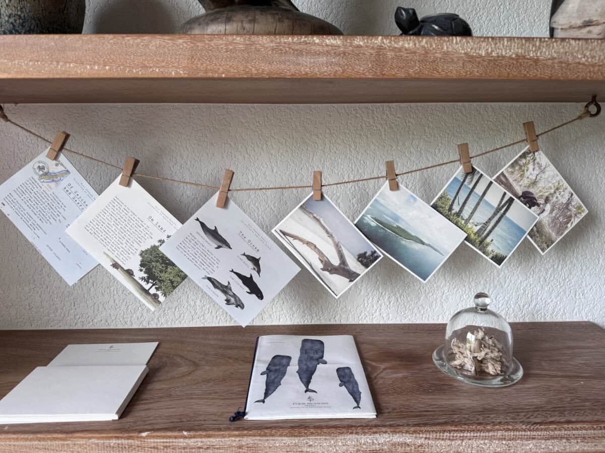 table with decorative pictures hanging above at Four Seasons Seychelles Resorts