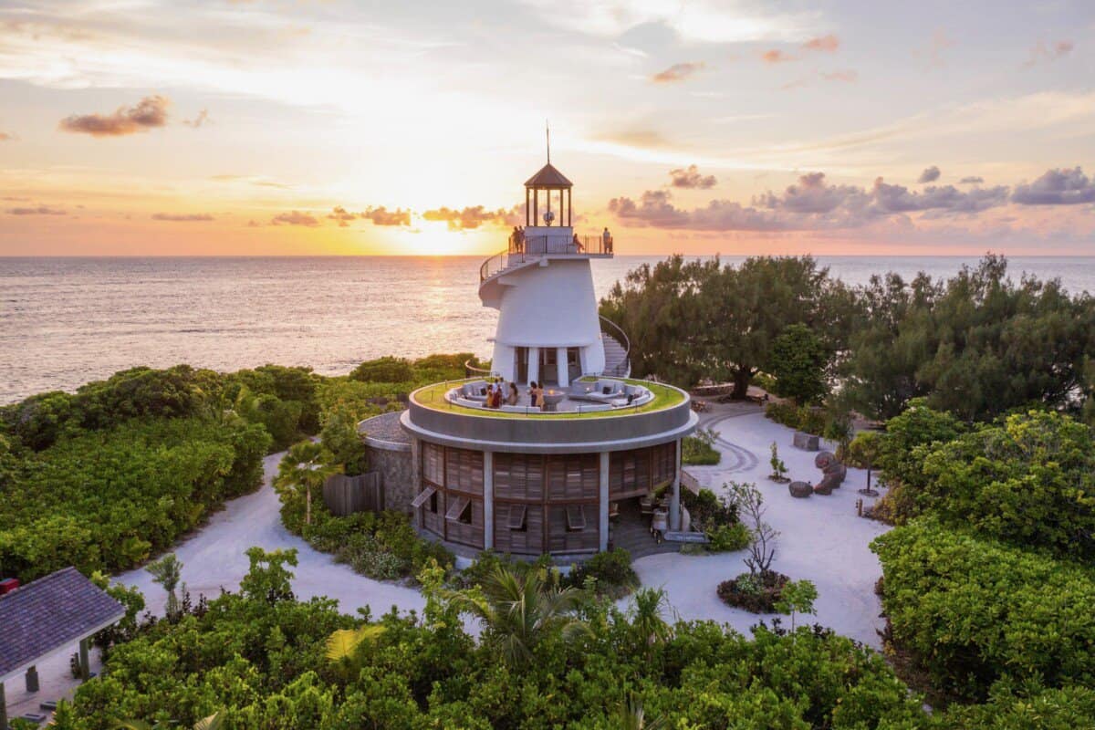 aerial view of lighthouse with sunset in backdrop