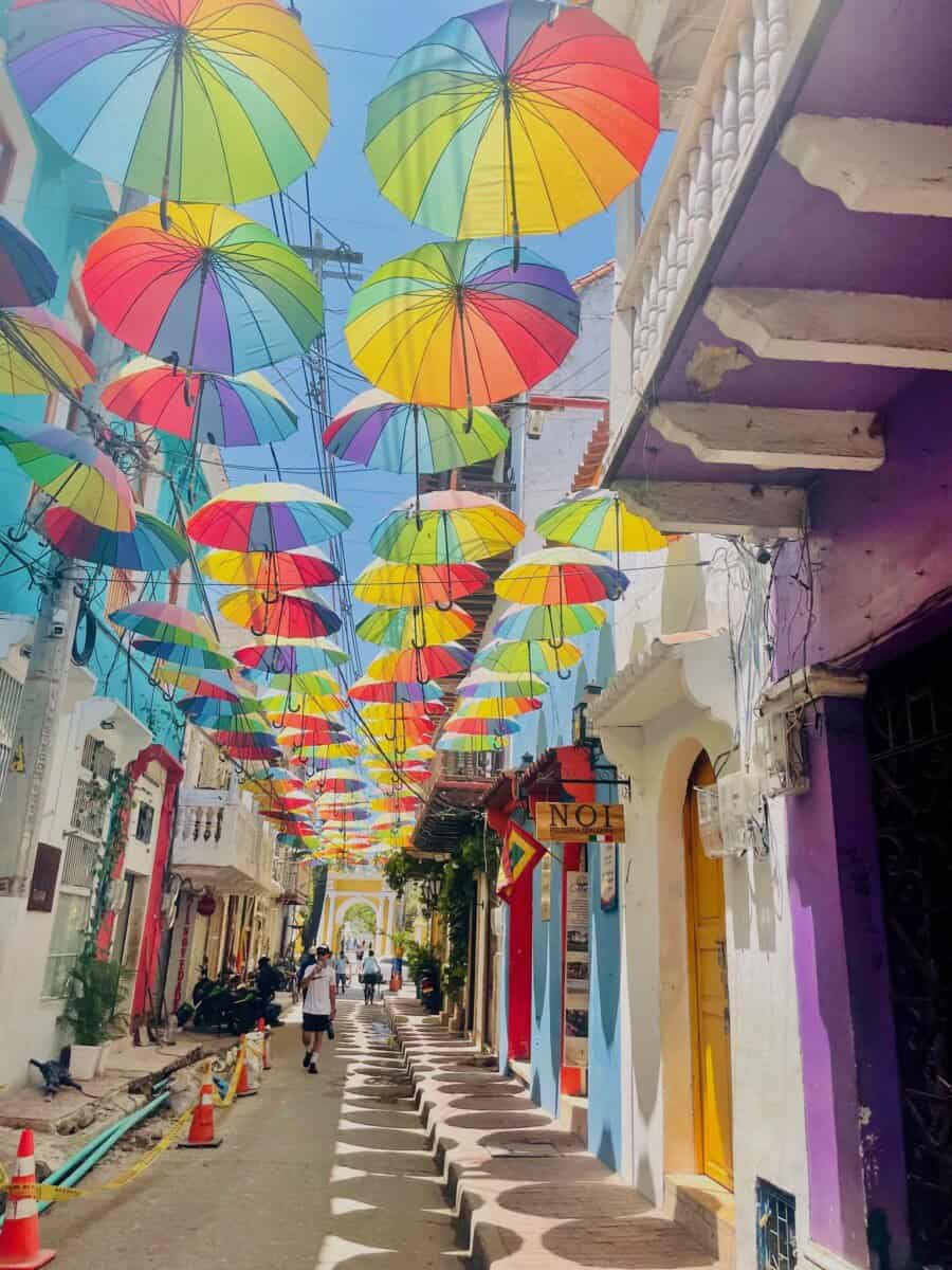 colorful street with umbrellas lining the top in Cartagena, Colombia