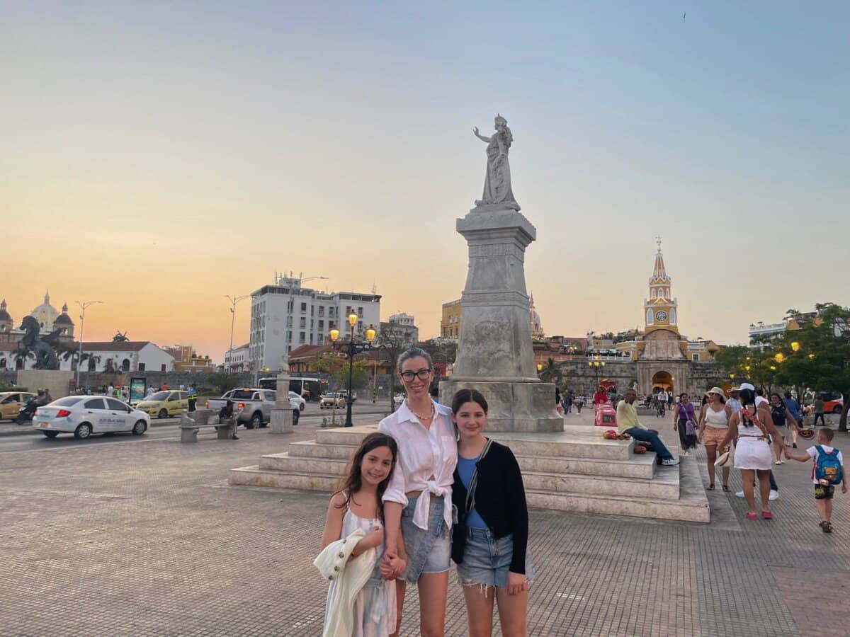 mother and two children posing in front of historic city center of Cartagena, Colombia