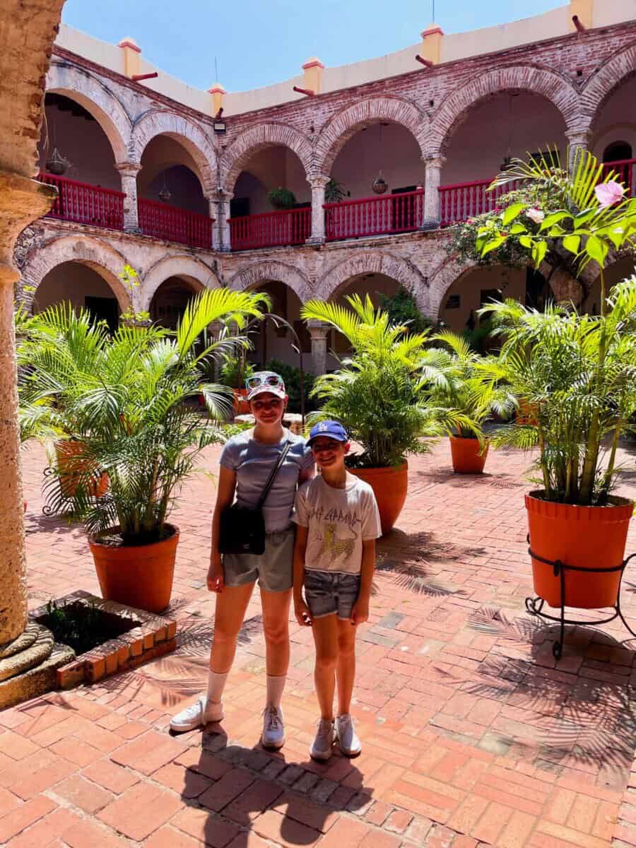 children posing in courtyard in Cartagena, Colombia