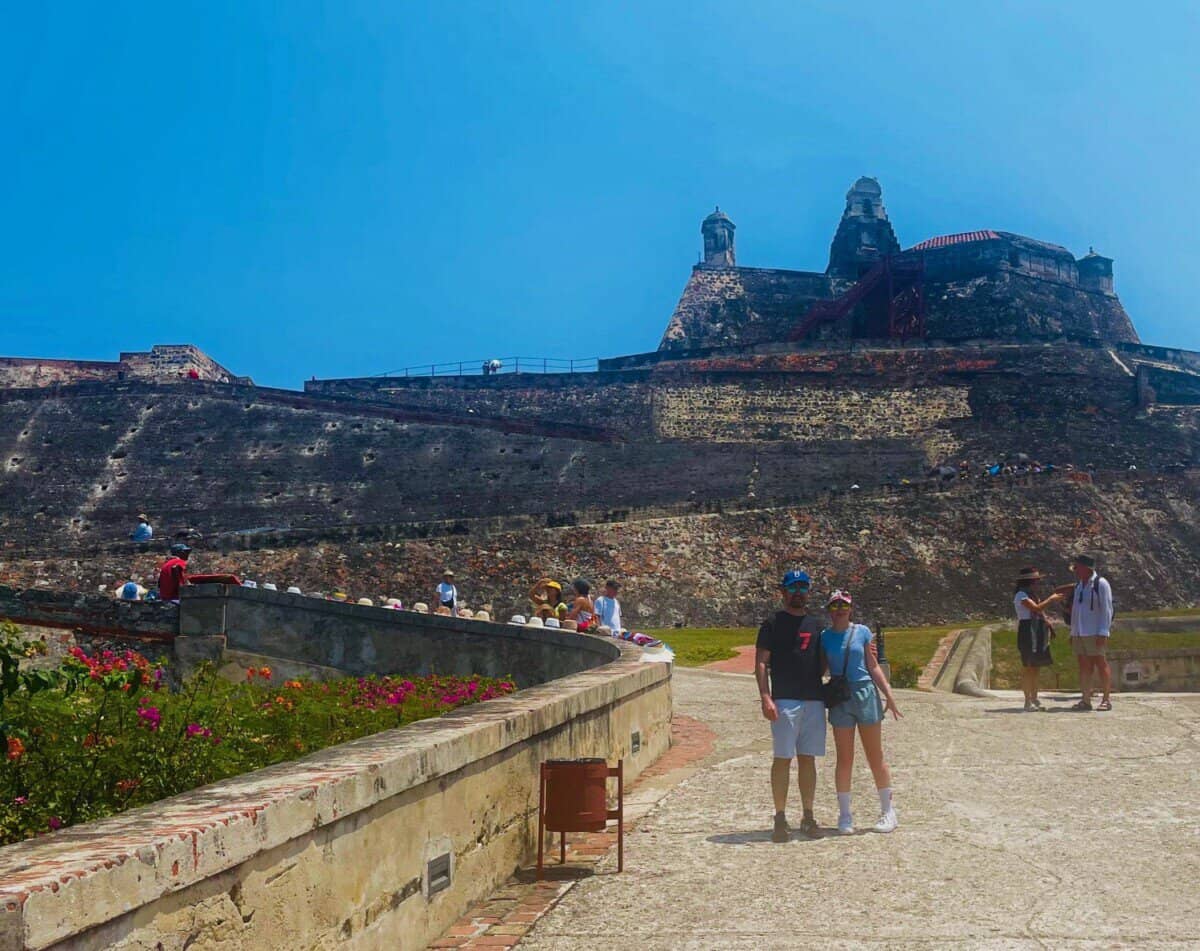 man and woman posing in front of historic landmark in Cartagena, Colombia