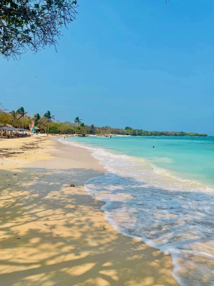 white sand beach with turquoise blue waters in Cartagena, Colombia