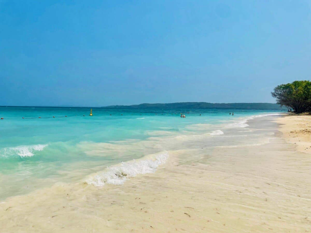 white sand beach with turquoise blue waters in Cartagena, Colombia