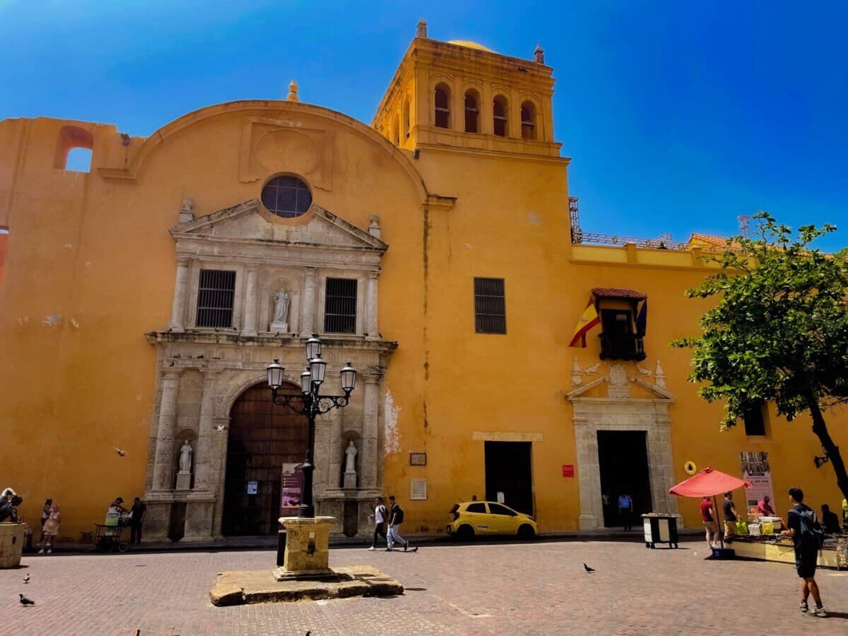 historic yellow building in Cartagena, Colombia with blue skies