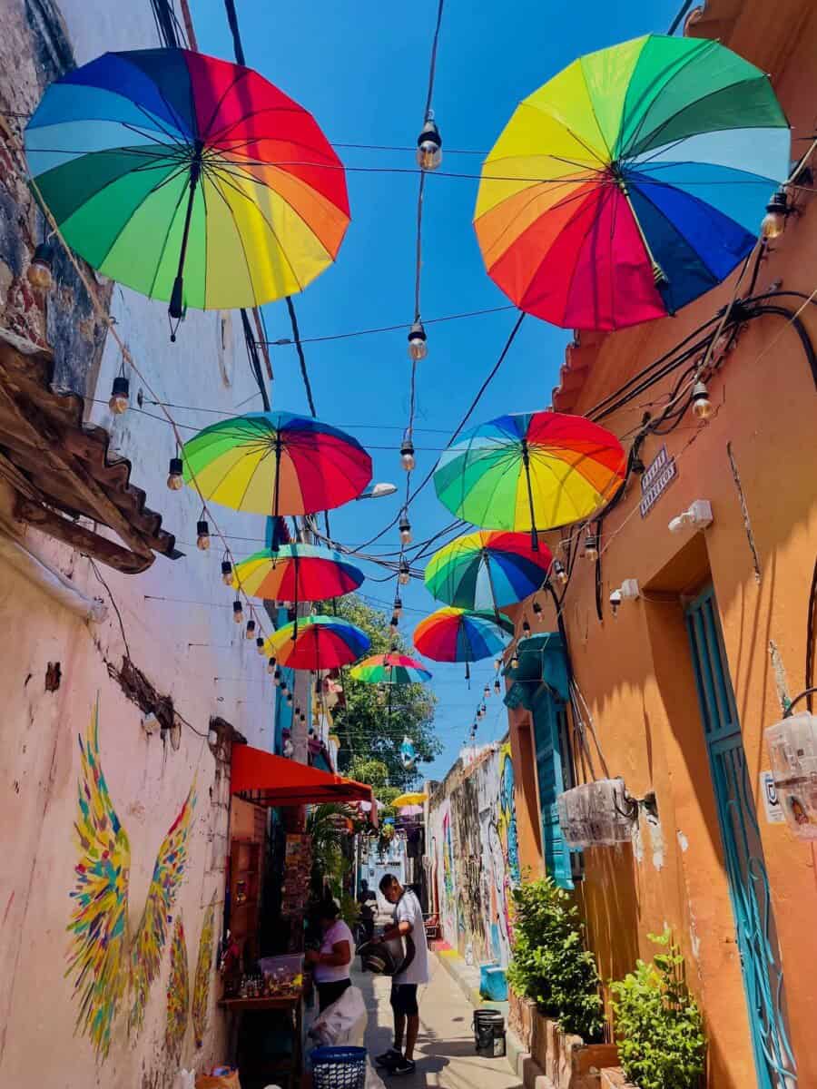 colorful umbrellas lining the tops of historic streets in Cartagena, Colombia