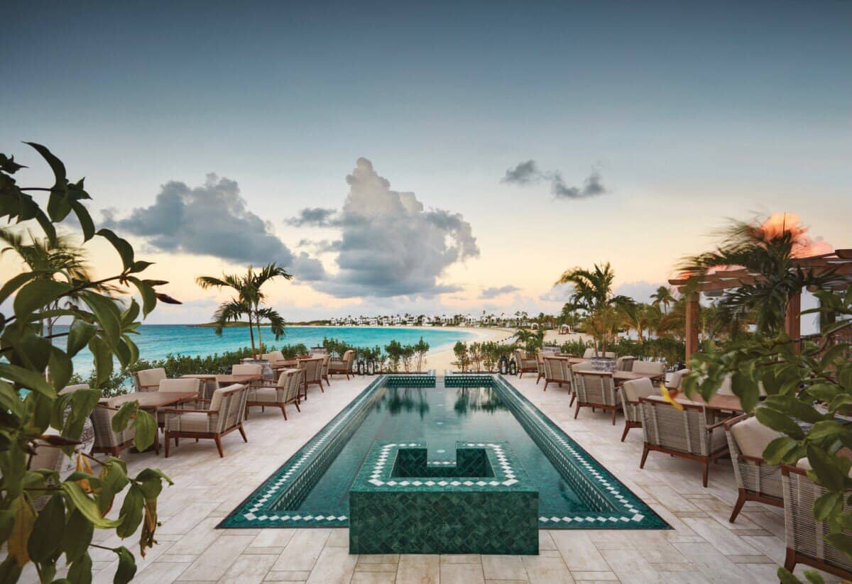 outdoor pool surrounded by palm trees at Anguilla Cap Juluca