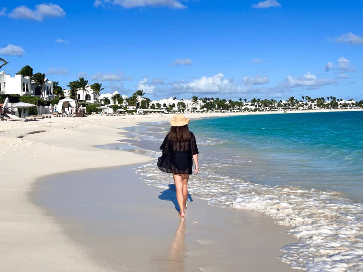 woman walking on the shoreline of the beach at Anguilla Cap Juluca