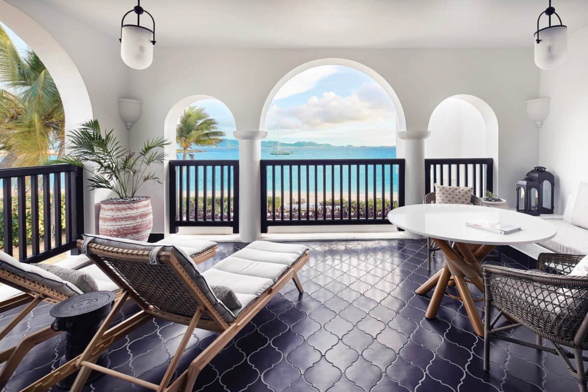 spacious outdoor balcony with white lounge chairs at Anguilla Cap Juluca