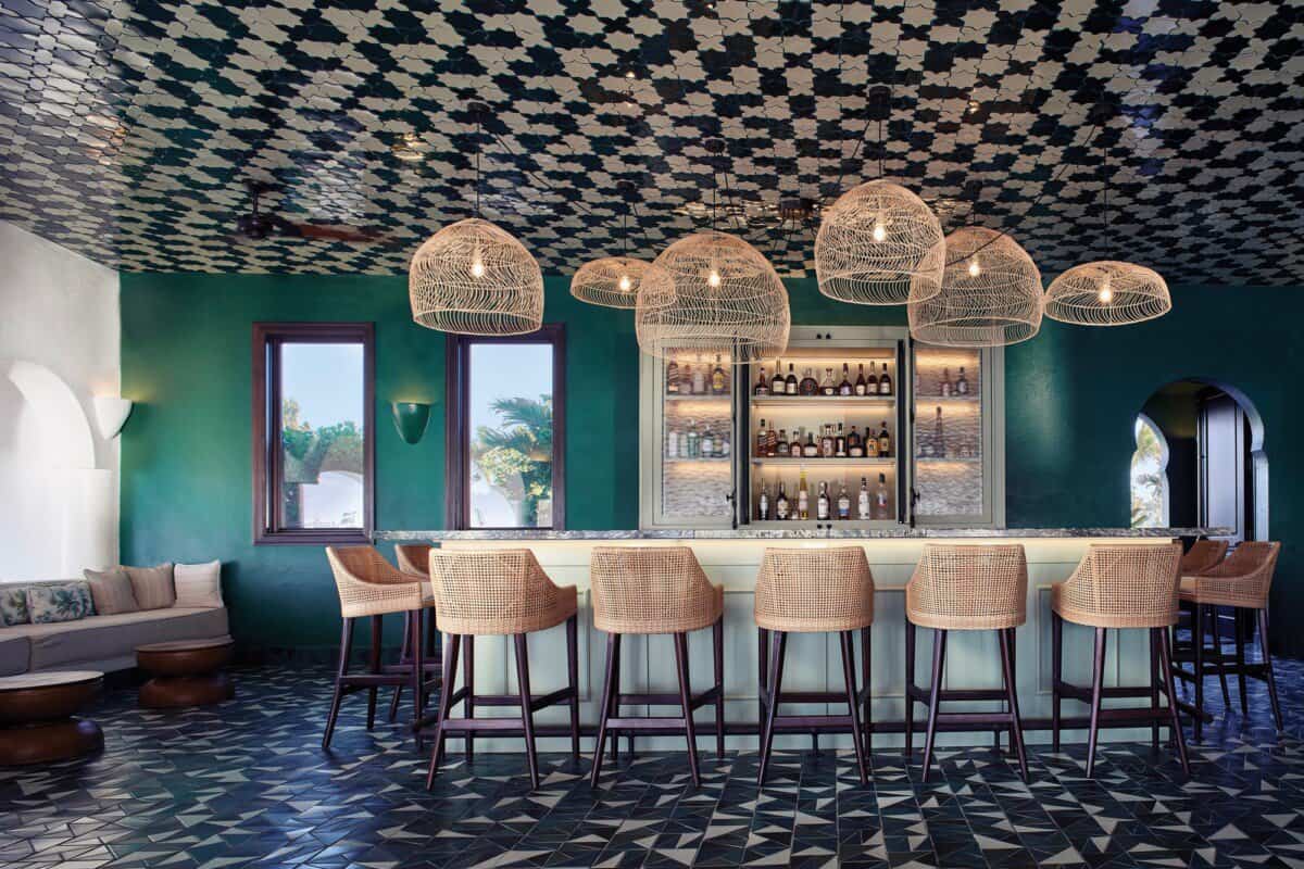 stylish restaurant interior with large lighting and teal walls at Anguilla Cap Juluca