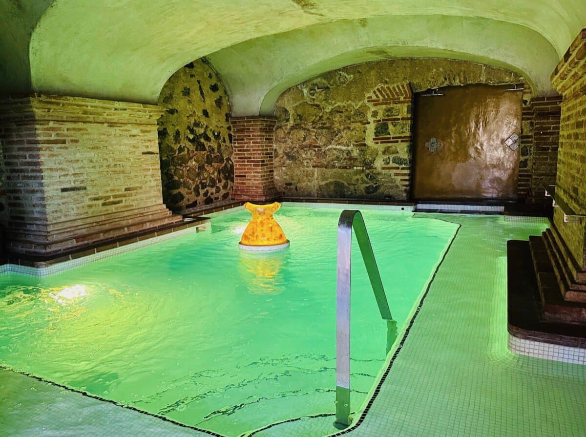 indoor pool with historic stone walls and ceilings