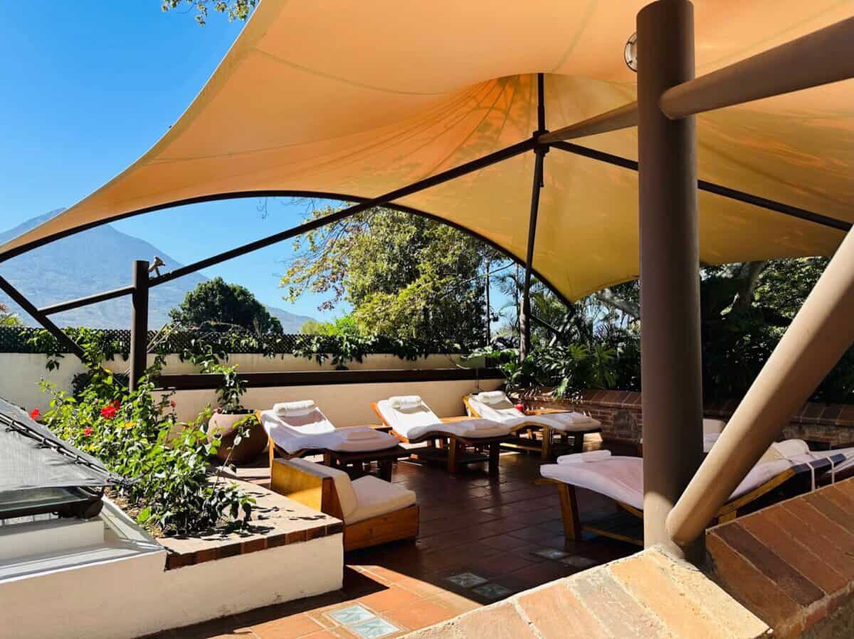 large outdoor balcony with cover and sun loungers
