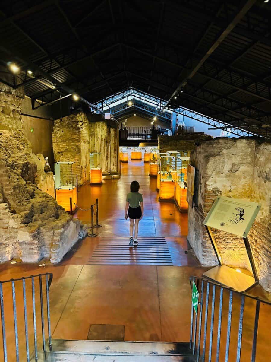 young woman walks down the stairs of a museum in Guatemala